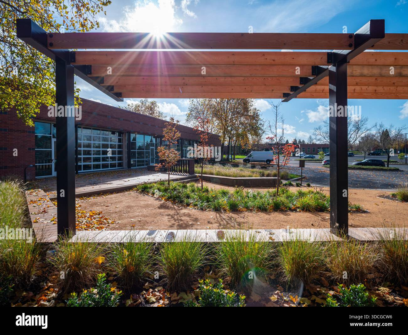 View Of A Sun-Drenched Pergola Framing A Modern Brick Building And ... within Outdoor Sun Garden Design